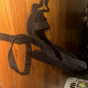 These heels are black and have a velvet texture.